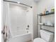 A tiled shower and bathtub with a white shower curtain at 4622 Fairy Tale Cir, Kissimmee, FL 34746