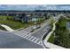 Aerial view of a community entrance with a pool, playground, and surrounding homes at 5226 Prairie Preserve Run, St Cloud, FL 34772