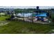 A playground with blue sunshades and a community pool with palm trees in the background at 5226 Prairie Preserve Run, St Cloud, FL 34772