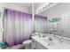 Bathroom features include a white vanity, a toilet, and a shower with a purple shower curtain at 523 Higher Combe Dr, Davenport, FL 33897