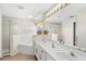 Spacious bathroom with shower, corner tub, double sinks, and large mirror with vanity lighting at 523 Higher Combe Dr, Davenport, FL 33897