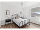 Bedroom featuring two black night stands, two mirrors, wood flooring, and one window at 523 Higher Combe Dr, Davenport, FL 33897