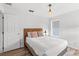 Bedroom featuring wood floors, a window, two pillows on the bed, and an end table with a lamp at 523 Higher Combe Dr, Davenport, FL 33897