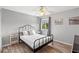 Bedroom featuring wood floors, ceiling fan, one window, and a night stand with lamp at 523 Higher Combe Dr, Davenport, FL 33897