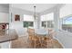 Bright breakfast nook with floral table cloth and large windows overlooking the backyard at 523 Higher Combe Dr, Davenport, FL 33897