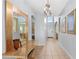 Elegant foyer with tile flooring, a decorative mirror, and a chandelier, creating a welcoming entrance at 523 Higher Combe Dr, Davenport, FL 33897