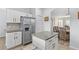 Kitchen with stainless steel refrigerator, island with granite countertop, and tile backsplash at 523 Higher Combe Dr, Davenport, FL 33897