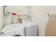 Laundry room featuring a washer, dryer, a wire rack, and an ironing board at 523 Higher Combe Dr, Davenport, FL 33897