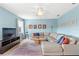 Inviting living room featuring a large sectional, ceiling fan, and light blue walls at 523 Higher Combe Dr, Davenport, FL 33897