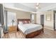 Tranquil main bedroom features a tray ceiling, ceiling fan, and wood-look flooring at 523 Higher Combe Dr, Davenport, FL 33897