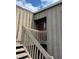 Close-up of a two-story entrance with wooden stairs leading to the unit at 5316 Burning Tree Dr # A-09-2, Orlando, FL 32811