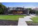 Expansive backyard with screened-in porch, lush lawn, and tiled walkway at 5524 Sail Ct, Orlando, FL 32819