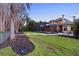 Backyard featuring a screened-in porch, stone patio, and well-manicured lawn at 5524 Sail Ct, Orlando, FL 32819