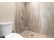 Modern bathroom featuring a glass-enclosed shower with neutral tile and stone flooring at 5524 Sail Ct, Orlando, FL 32819