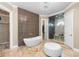 Luxury primary bathroom with soaking tub, glass shower, and walk-in closet access at 5524 Sail Ct, Orlando, FL 32819