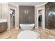 Luxury primary bathroom with soaking tub, glass shower, and dual walk-in closet access at 5524 Sail Ct, Orlando, FL 32819