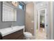 Modern bathroom featuring a sleek vanity, toilet, and a doorway leading into a glass shower at 5524 Sail Ct, Orlando, FL 32819