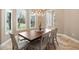 Formal dining room with wood table, seating for six, and a modern chandelier at 5524 Sail Ct, Orlando, FL 32819