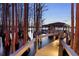 View of the covered dock with lake access, from the well-lit walkway at 5524 Sail Ct, Orlando, FL 32819