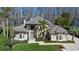 Elegant home featuring manicured landscaping, decorative palm trees, and a patterned stone driveway at 5524 Sail Ct, Orlando, FL 32819