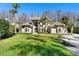 Stately two-story home on a large lot with a manicured lawn and mature landscaping at 5524 Sail Ct, Orlando, FL 32819