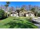 Beautiful, traditional-style home showcasing manicured lawn, lush greenery, and a symmetrical facade at 5524 Sail Ct, Orlando, FL 32819