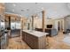 Open concept kitchen with stainless appliances, center island, and bar seating flowing into the living room at 5524 Sail Ct, Orlando, FL 32819