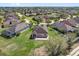 Aerial view of a home with a patio and lush green lawn in a residential neighborhood at 556 Grande Dr, Davenport, FL 33837