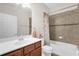 The bathroom has a large mirror, vanity with cabinetry, toilet, and bathtub with a shower at 556 Grande Dr, Davenport, FL 33837