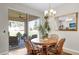 Bright dining area with a chandelier, and sliding glass doors leading to a screened in patio with a grill at 556 Grande Dr, Davenport, FL 33837