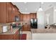 Modern kitchen featuring stainless steel appliances, wood cabinetry, and granite countertops at 556 Grande Dr, Davenport, FL 33837