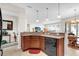 Open kitchen area with granite countertops, stainless steel dishwasher, and wood cabinetry at 556 Grande Dr, Davenport, FL 33837