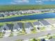 This aerial shows a home with a lake in the backyard, including a tree line and neighborhood view at 585 Mosaic Blvd, Daytona Beach, FL 32124