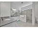 Bright bathroom featuring tiled shower, white cabinets, dual sinks, and ample counter space at 585 Mosaic Blvd, Daytona Beach, FL 32124