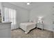 Cozy bedroom features neutral decor, a comfortable bed, and soft natural light at 585 Mosaic Blvd, Daytona Beach, FL 32124