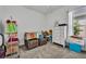 This bedroom includes carpeted floors, a dresser, and a large window with lots of sunlight at 585 Mosaic Blvd, Daytona Beach, FL 32124