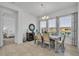 Elegant dining room with a chandelier, large windows, and a view of the backyard at 585 Mosaic Blvd, Daytona Beach, FL 32124