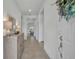 Bright entryway featuring neutral tile flooring, a decorative mirror, and a hall table at 585 Mosaic Blvd, Daytona Beach, FL 32124