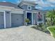 Charming home with a two-car garage, landscaped yard, and a welcoming front porch at 585 Mosaic Blvd, Daytona Beach, FL 32124