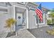 Close up of a charming front entrance with an American flag and welcoming decor at 585 Mosaic Blvd, Daytona Beach, FL 32124