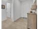 The hallway has tiled floors, and includes a wooden decorative cabinet and doorways to other rooms at 585 Mosaic Blvd, Daytona Beach, FL 32124