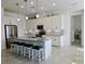 Bright kitchen boasts stainless steel appliances, a mosaic backsplash, and an island with bar stool seating at 585 Mosaic Blvd, Daytona Beach, FL 32124