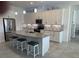 This modern kitchen features stainless steel appliances, a stylish tile backsplash, and barstool seating at the island at 585 Mosaic Blvd, Daytona Beach, FL 32124