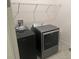 A functional laundry room features modern appliances and storage space for efficient chore management at 585 Mosaic Blvd, Daytona Beach, FL 32124