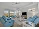 Bright living room with tile floors, modern furniture, and a sliding glass door to patio at 585 Mosaic Blvd, Daytona Beach, FL 32124