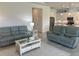 The living room is furnished with comfortable seating and leads to the modern kitchen with stainless steel appliances at 585 Mosaic Blvd, Daytona Beach, FL 32124