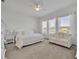 Serene main bedroom featuring white furniture, soft carpet, and ample natural light at 585 Mosaic Blvd, Daytona Beach, FL 32124