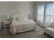 A serene bedroom offers soft, natural light and a peaceful retreat with neutral tones at 585 Mosaic Blvd, Daytona Beach, FL 32124