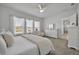Bright main bedroom with a ceiling fan, large windows, and neutral decor at 585 Mosaic Blvd, Daytona Beach, FL 32124