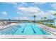 Community pool with swimming lanes, sun loungers, and palm trees at 585 Mosaic Blvd, Daytona Beach, FL 32124